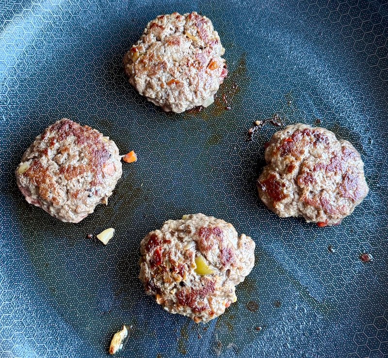 these are mini burgers being cooked