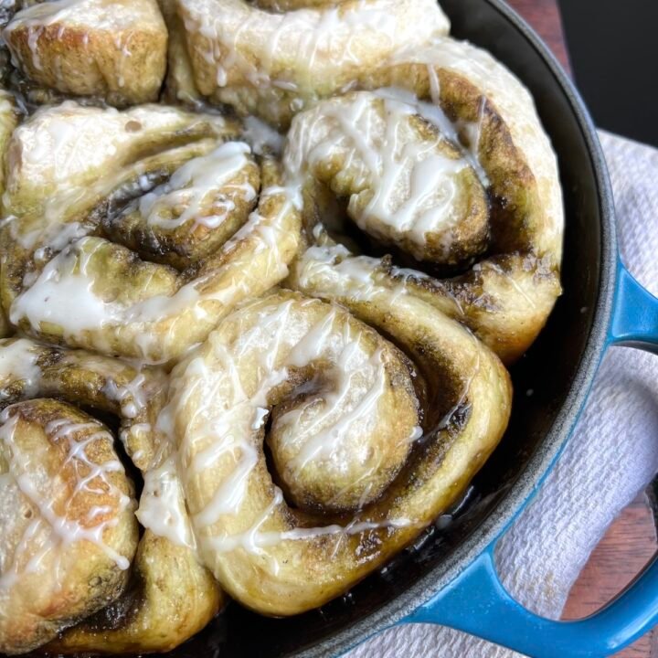 this is a skillet of homemade sourdough matcha cinnamon rolls