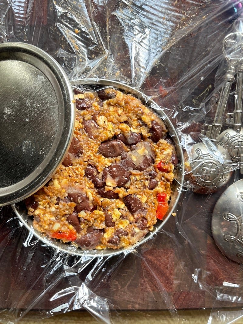 this is a photo of black bean burgers being pressed into a wide mouth mason jar