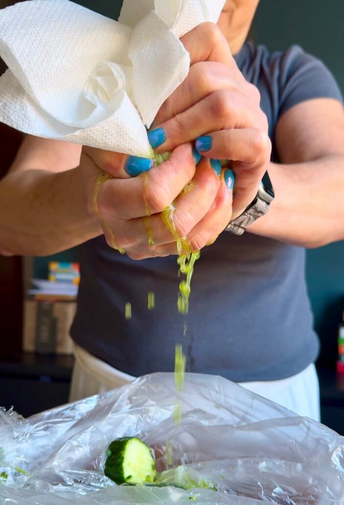 this is grated cucumbers in a paper towel being squeezed dry
